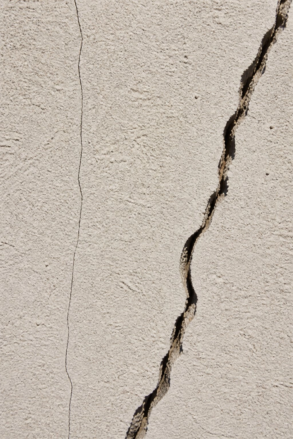 Stucco cracks on NYC building facade