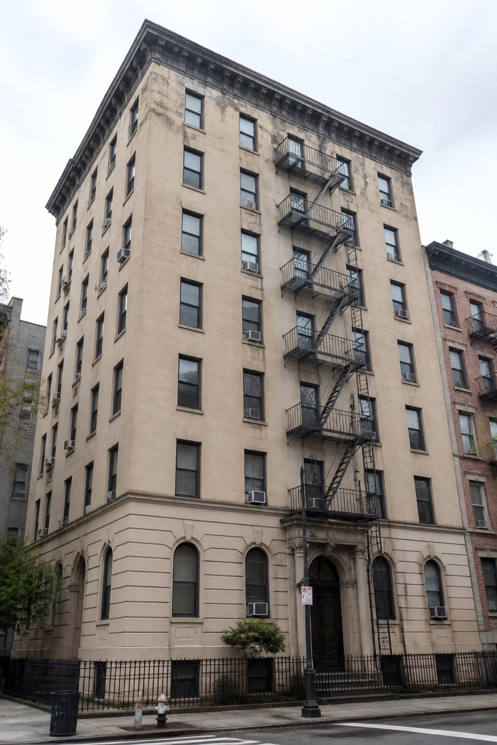 NYC apartment building with fire escape - concrete facade restoration nyc